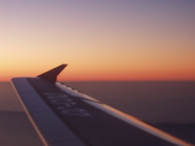 This is the wing of an aeroplane in the sunset at 30.000 feet.