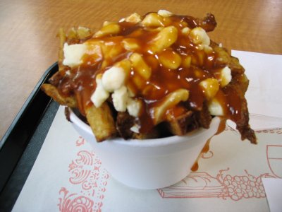 These are soggy chips with cheese curd and gravy (i.e. Poutine).